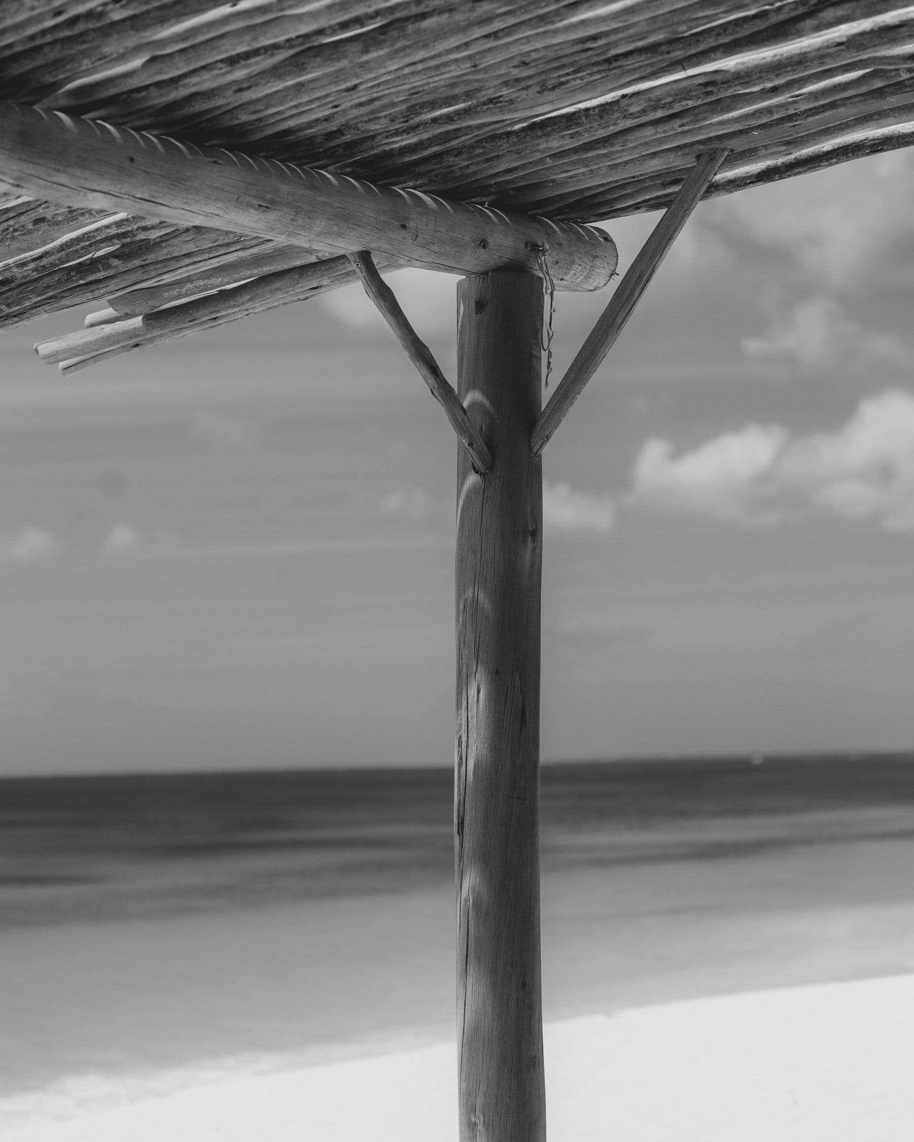 A thatched parasol against the sea and sky